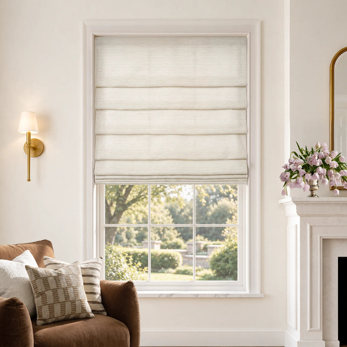 Soft fold Roman shades in Gilded Cream light-filtering fabric, partially raised to show cascading folds.
