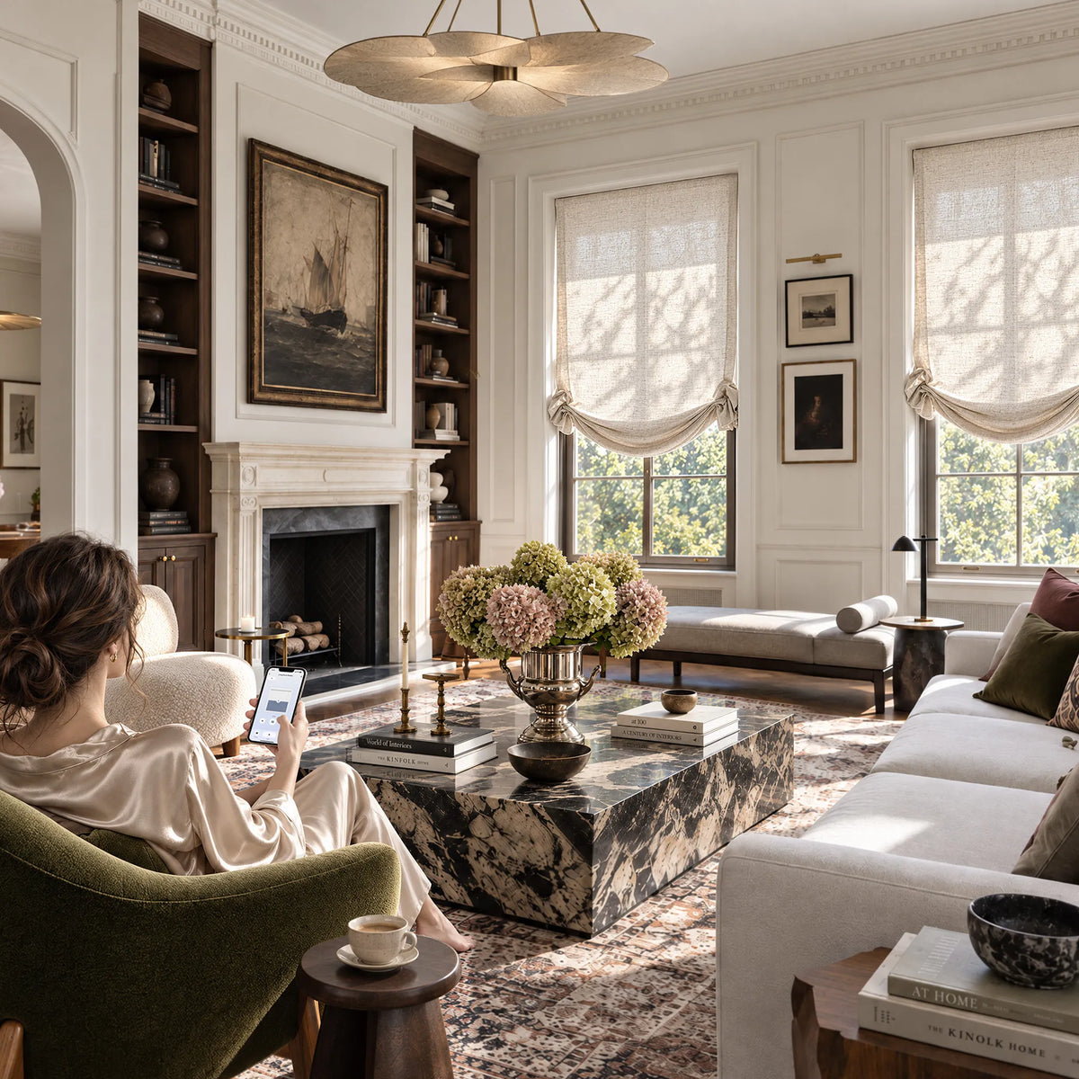 A person using a smartphone beside light-filtering swag Roman shades in a living room.