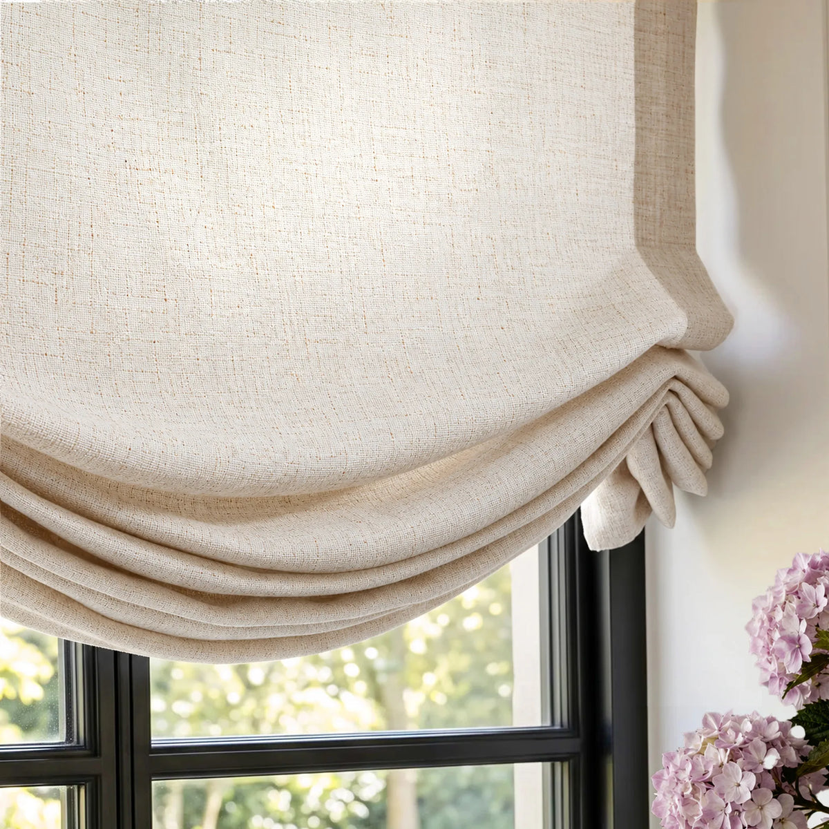 Close-up of swag Roman shade fabric gathered into soft curved folds.