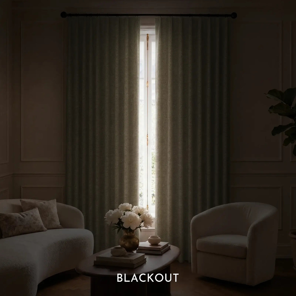Living room with light gray curtains, a sofa, and a chair, featuring the word 'BLACKOUT'.