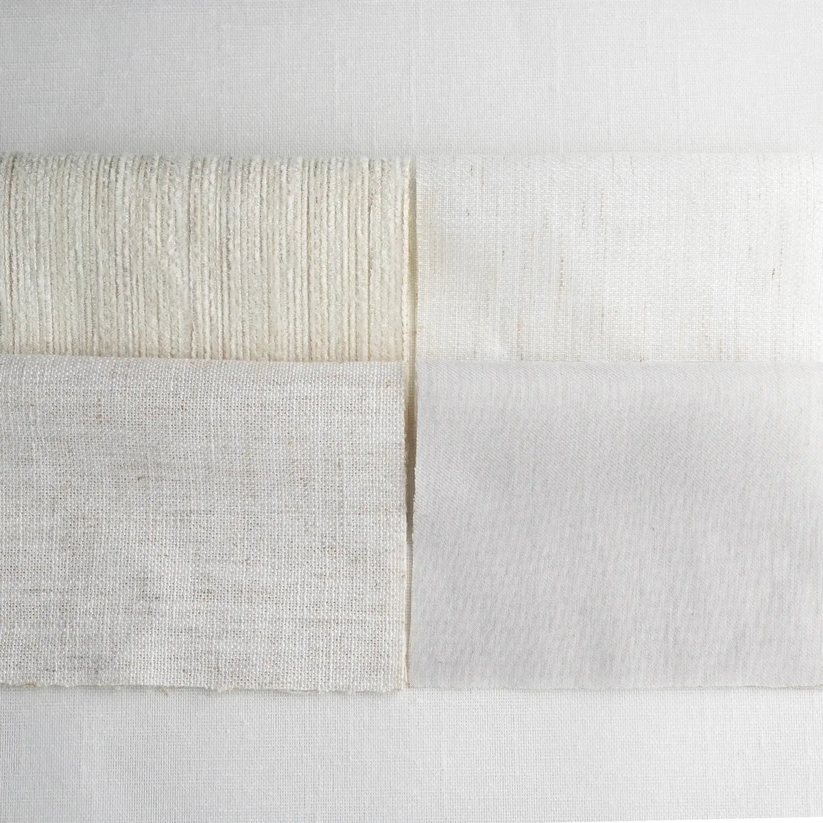 Close-up of textured fabric with a neutral color palette on a light gray background