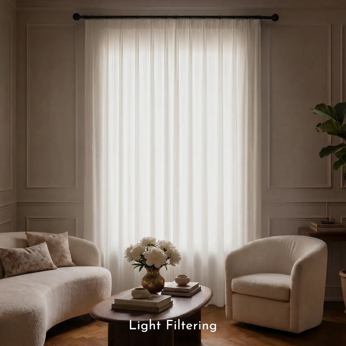 Living room with light filtering curtains, sofa, and armchair.