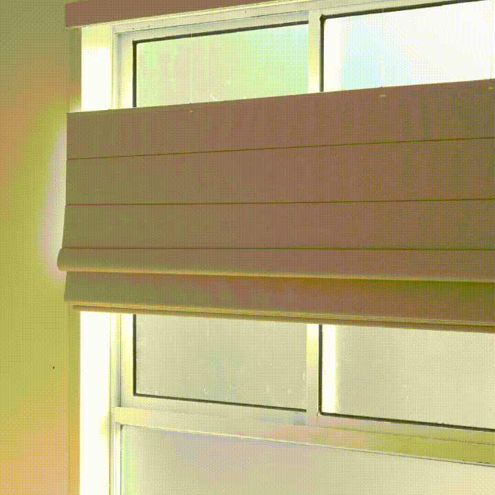 The Roman shade lowers from the top to welcome natural light while maintaining privacy at the lower part of the window.