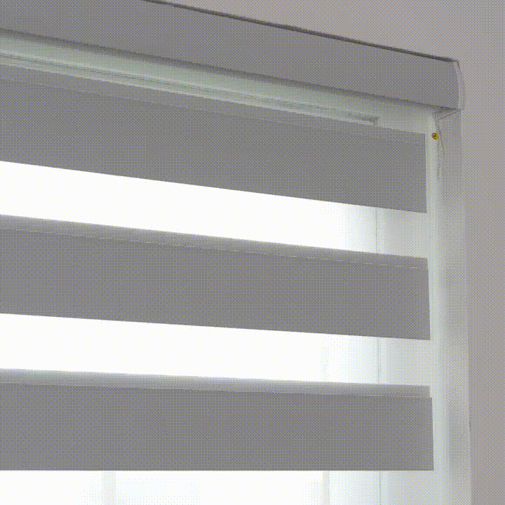 The zebra blind raises smoothly into the headrail, fully opening the window for a brighter, unobstructed view.